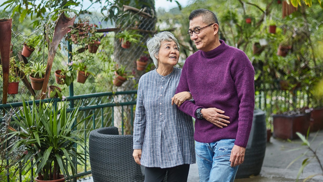 An old couple is walking in the garden; image used for HSBC Malaysia how to stay financially healthy article page.
