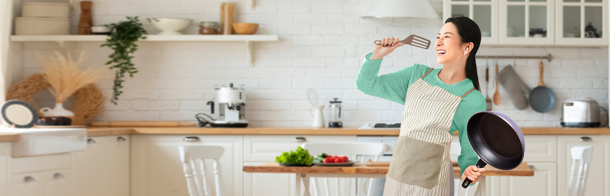 A woman is standing in the kitchen; image used for HSBC Malaysia cash back promotion page.