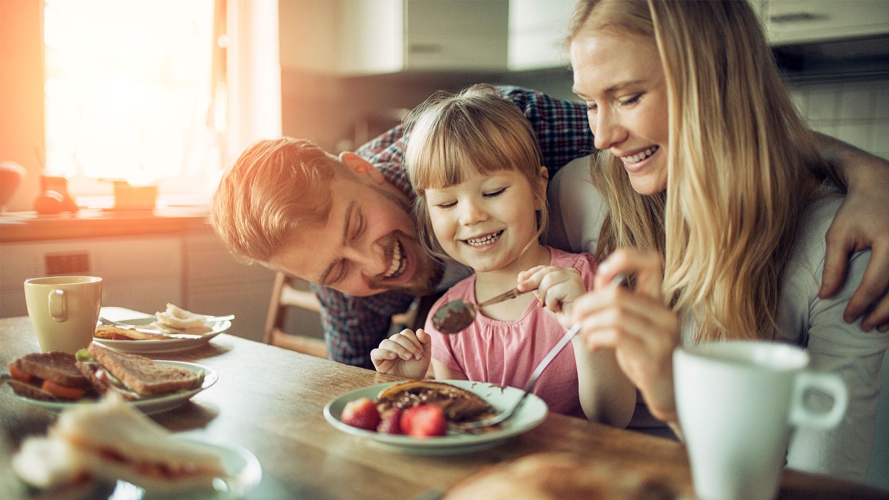 Happy family sharing a meal. Image used for HSBC Malaysia Insurance / Takaful page.