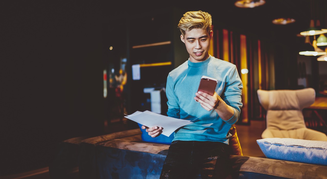 A yellow haired boy looking at his phone; image used for HSBC Malaysia's Why sustainable investing could become the new normal page.